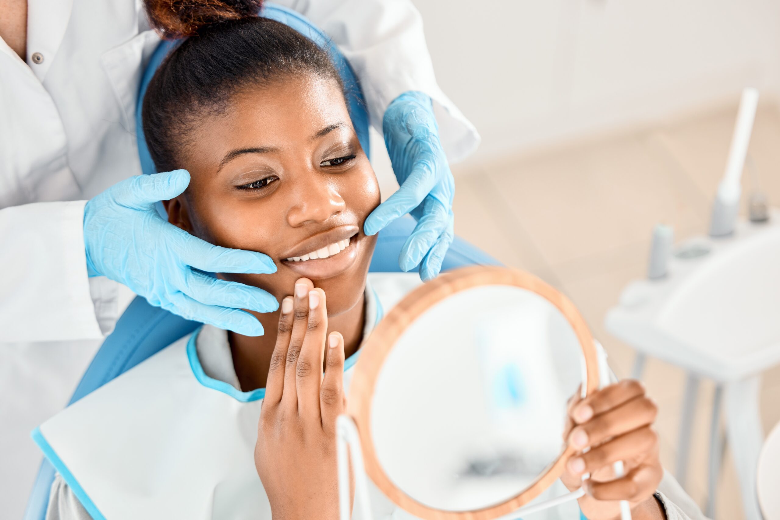 dentist showing a young woman her perfect, healthy smile
